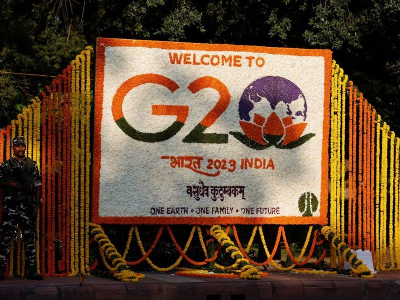 a security force personnel stands guard next to a hoarding decorated with flowers on a pavement ahead of the g20 summit in new delhi india september 8 2023 photo reuters