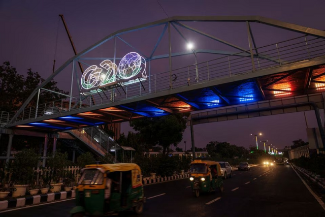 traffic moves past under a g20 logo installed on a pedestrian bridge in front of the main venue of the summit in new delhi india august 24 2023 photo reuters traffic moves past under a g20 logo installed on a pedestrian bridge in front of the main venue of the summit in new delhi india august 24 2023 photo reuters