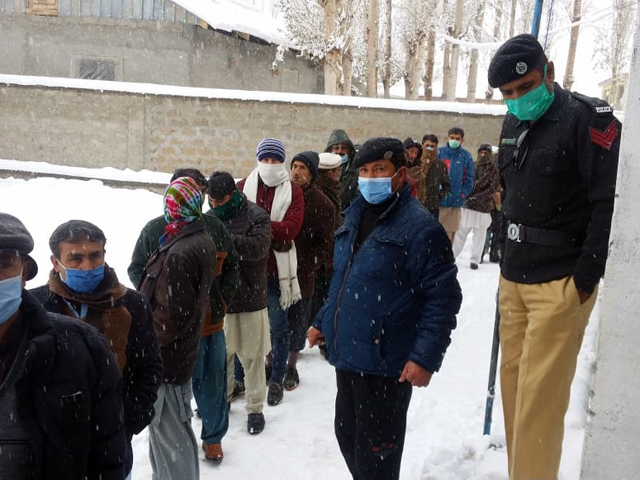 voters waiting in snow and extreme cold weather for their turn to cast vote in gilgit photo express