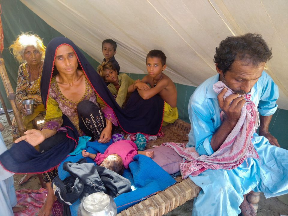 Badar Bibi, 29 a flood victim who is sick 6-year-old son died in the relief camp she and her family hiding, sitting in camp after rains and floods in the rainy season in Sehwan, Pakistan, September 9, 2022 REUTERS