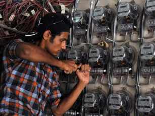 a technician from karachi electric pakistan s largest city s power supply company checks electricity meters at a residential building in karachi photo afp