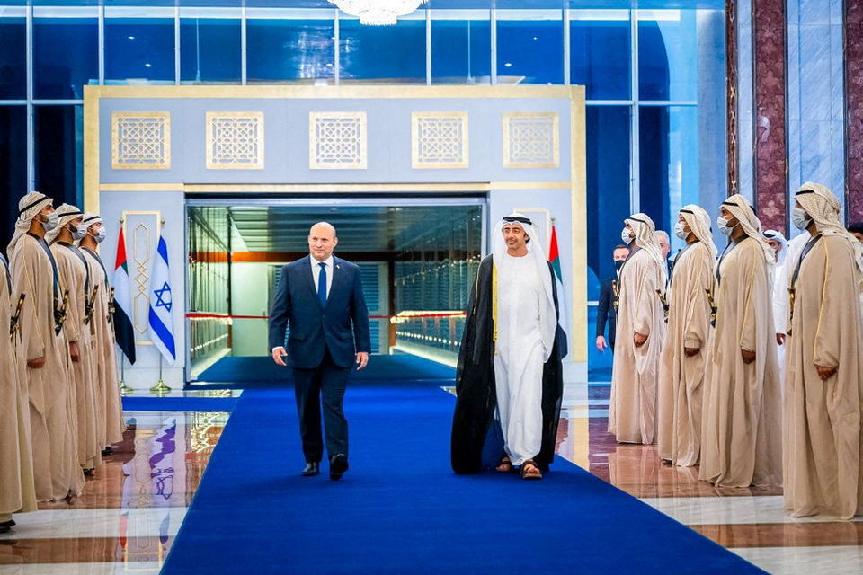 israeli prime minister naftali bennett walks with united arab emirates foreign minister sheikh abdullah bin zayed al nahyan during a welcoming ceremony upon his arrival in abu dhabi united arab emirates december 12 2021 picture taken december 12 2021 wam handout via reuters