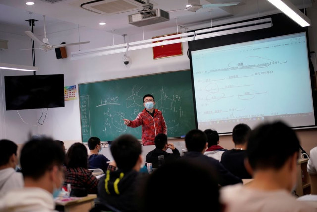 a teacher wearing a face mask teaches inside a classroom during a government organised media tour at a high school as more students returned to campus following the coronavirus disease covid 19 outbreak in shanghai china may 7 2020 reuters a teacher wearing a face mask teaches inside a classroom during a government organised media tour at a high school as more students returned to campus following the coronavirus disease covid 19 outbreak in shanghai china may 7 2020 reuters