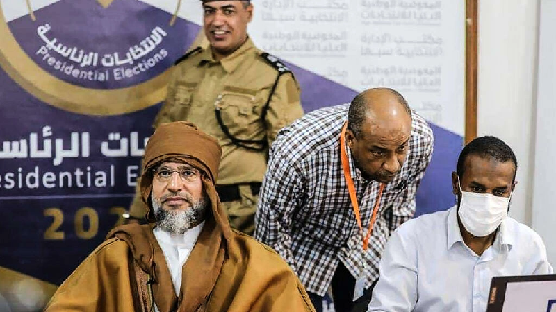 a handout picture released by the the libyan high national commission facebook page on november 14 2021 shows seif al islam kadhafi l registering to run in the country s december presidential polls in libya s southern city of sebha photo afp