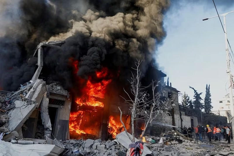 palestinian firefighters work to extinguish a fire in a house after an israeli strike in khan younis in the southern gaza strip december 9 2023 photo reuters