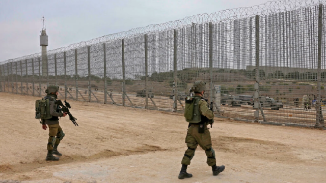 israeli soldiers walk by the fence along the border with the gaza strip in southern israel photo afp israeli soldiers walk by the fence along the border with the gaza strip in southern israel photo afp