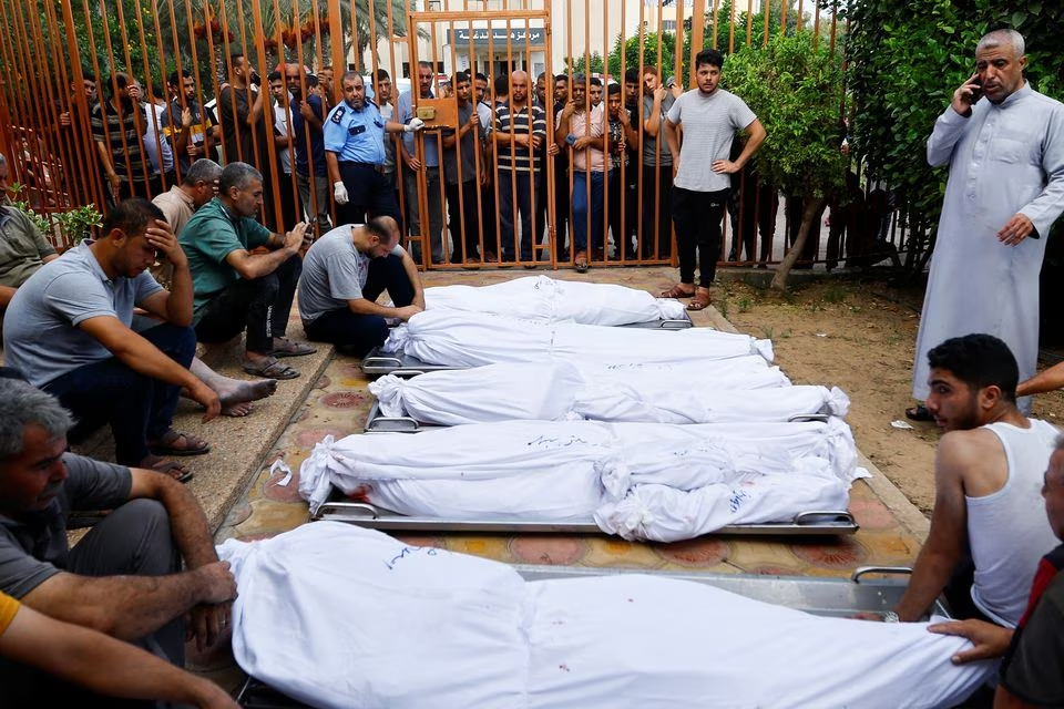 Mourners at the funeral of Palestinian members of al-Agha family, who were killed in Israeli strikes, in Khan Younis in the southern Gaza Strip, October 11. PHOTO: REUTERS