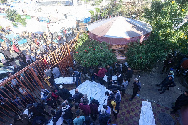 The shrouded bodies of people killed in Israeli bombardment on Khan Yunis in the southern Gaza Strip are laid out for identification by relatives in front of the morgue of the Nasser hospital on December 15, 2023, as battles continue between Israel and the Palestinian resistance group Hamas. PHOTO: AFP