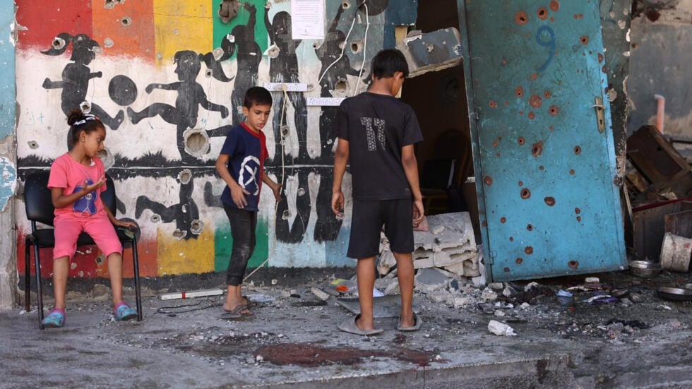 children inspect the damage at the site of the israeli strike on a school housing displaced palestinians on september 21 2024 photo afp