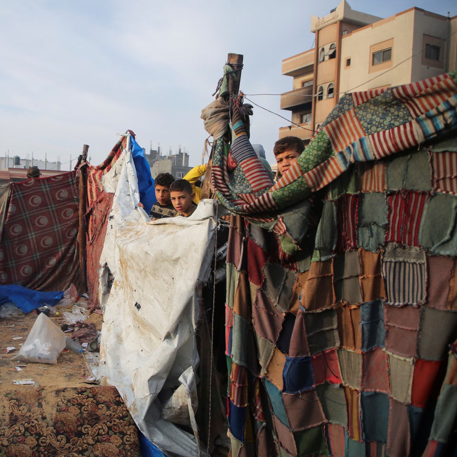 palestinian children stand at the site of an israeli strike on a tent housing displaced people in khan younis in the southern gaza strip on november 9 2024 photo reuters