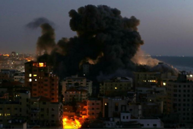 smoke rises from a building after it was destroyed by israeli air strikes amid a flare up of israeli palestinian violence in gaza may 11 2021 photos reuters afp smoke rises from a building after it was destroyed by israeli air strikes amid a flare up of israeli palestinian violence in gaza may 11 2021 photos reuters afp