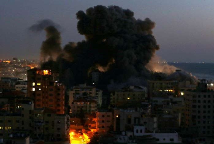 smoke rises from a building after it was destroyed by israeli air strikes amid a flare up of israeli palestinian violence in gaza may 11 2021 photos reuters afp