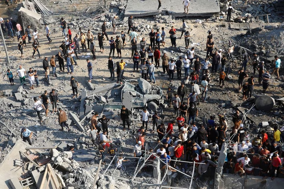 Palestinians search for casualties under the rubble in the aftermath of Israeli strikes, in Khan Younis in the southern Gaza Strip, October 14, 2023. PHOTO: REUTERS