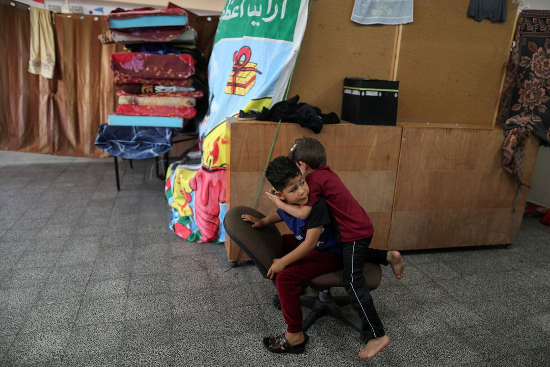 sons of palestinian man ihab el attar who according to him lost four members of his family when an israeli strike hit their house and injured him play at a united nations run school where they take refuge in gaza city may 18 2021 photo reuters