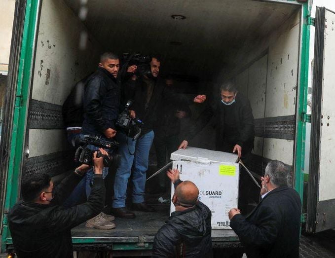 palestinians prepare to unload a batch of the first shipment of the coronavirus disease covid 19 vaccines in gaza city february 17 2021 photo reuters file