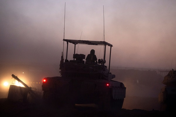 An Israeli military vehicle maneuvers during the ongoing ground invasion of the Gaza Strip.  PHOTO: Reuters