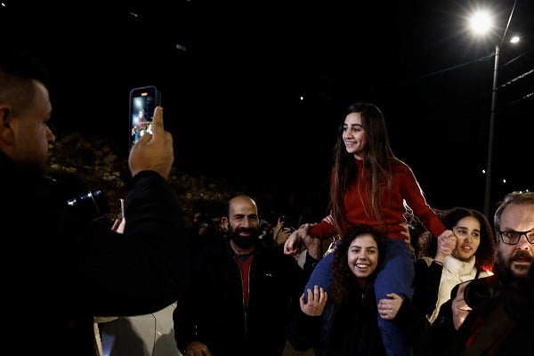 Newly expelled Palestinian restrained Rouba Assi is carried by supporters during a acquire rite for prisoners liberated from Israeli jails. PHOTO: AFP