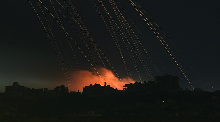 This long exposure picture taken from southern Israel near the border with the Gaza Strip shows Israeli shells falling on north Gaza. PHOTO: AFP