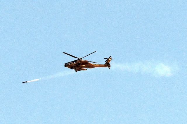 an israeli air force attack helicopter fires a missile while flying over the northern gaza strip photo afp an israeli air force attack helicopter fires a missile while flying over the northern gaza strip photo afp