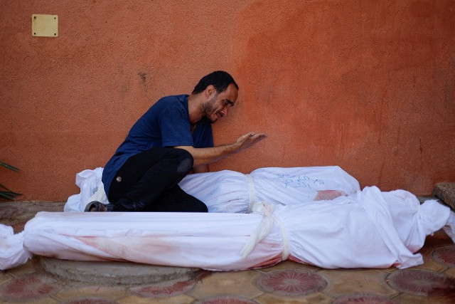 mohammed al akhras cries next to the bodies of his daughter jana and his wife who were killed by israeli strikes in gaza photo reuters