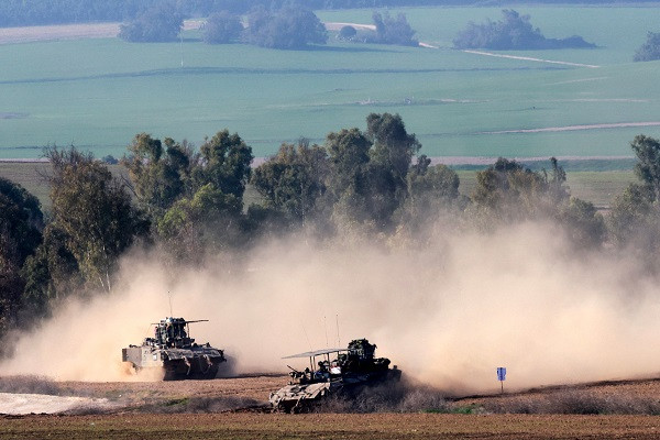 this picture taken from from southern israel shows israeli armoured vehicles rolling along the border with the gaza strip photo afp