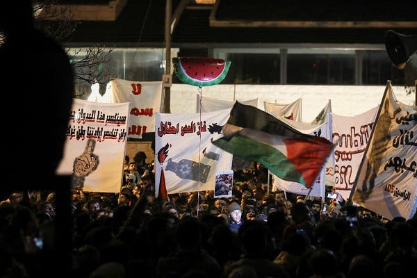 People take partial in a criticism in support of Palestinians in Gaza nearby a US embassy in Amman, Jordan. PHOTO: Reuters