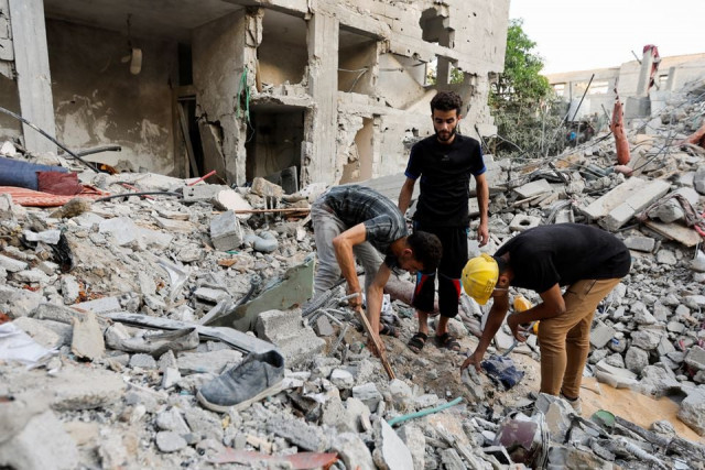 palestinians men look through debris as people gather at the scene where senior commander of islamic jihad group khaled mansour was killed in israeli strikes in rafah in the southern gaza strip august 7 2022 reuters palestinians men look through debris as people gather at the scene where senior commander of islamic jihad group khaled mansour was killed in israeli strikes in rafah in the southern gaza strip august 7 2022 reuters