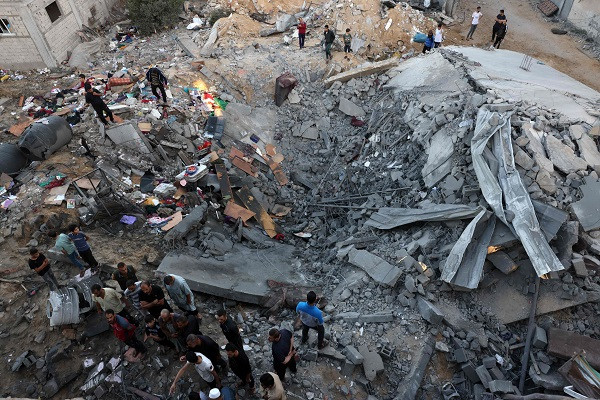 Palistinians check the rubble of a building destroyed in an Israeli bombardment in Rafah in the southern Gaza Strip. PHOTO: AFP
