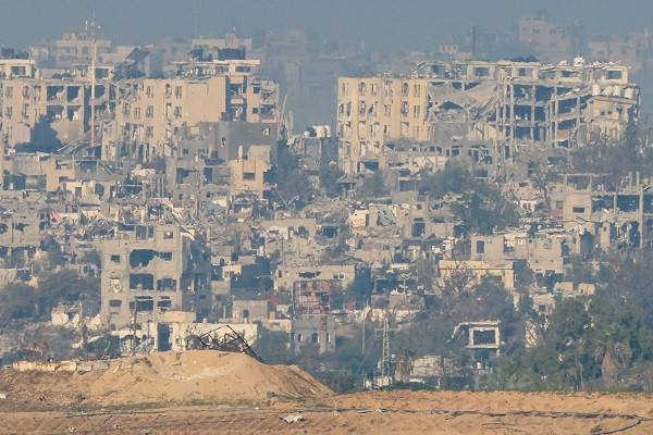 A picture taken from the border between Israel and Gaza shows buildings heavily destroyed by Israeli strikes in the Gaza Strip. PHOTO AFP