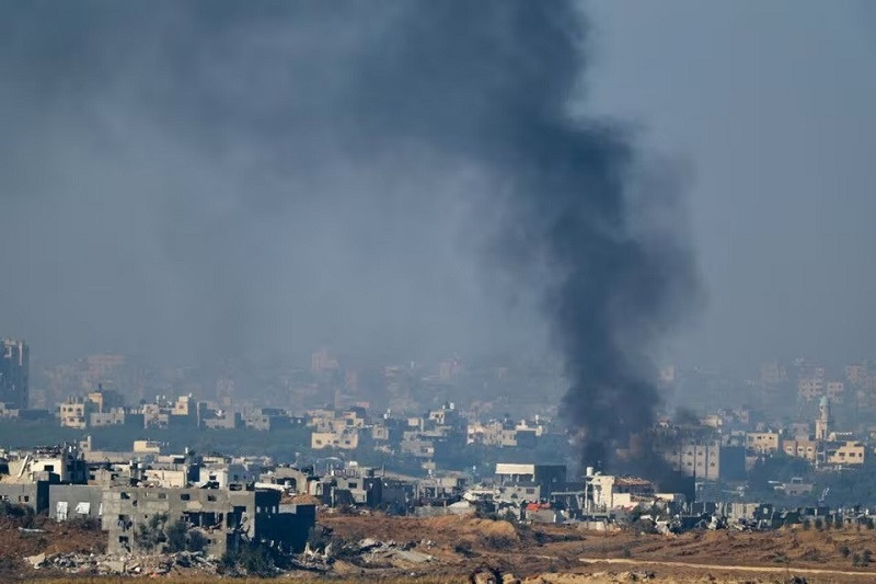 Smoke rises amid damaged buildings in Gaza as seen from southern Israel, December 2, 2023. PHOTO: REUTERS