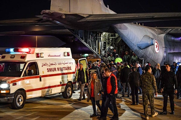 rescuers and soldiers stand near a c130 hercules military aircraft and an ambulance upon arrival of wounded palestinian from the gaza strip at tunis carthage airport on december 3 photo afp