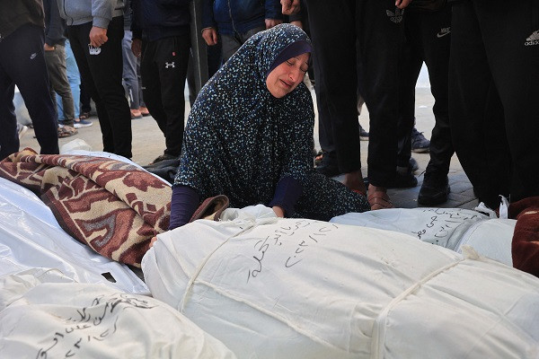 a woman mourns over the bodies of family members killed during israeli bombardment overnight at al najjar hospital in rafah photo afp