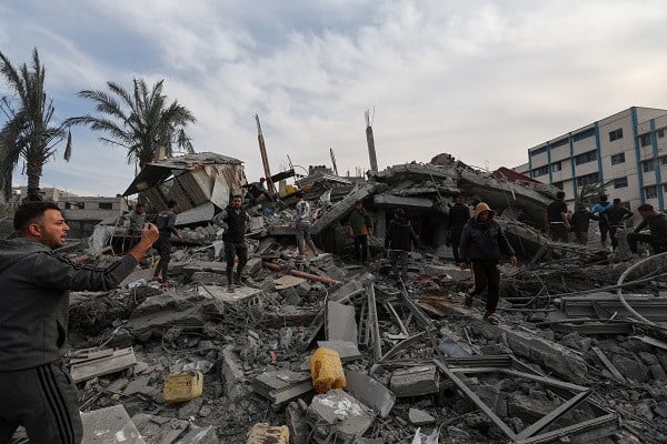 Palestinians search for casualties at the site of an Israeli strike on a house in the southern Gaza Strip. PHOTO: Reuters