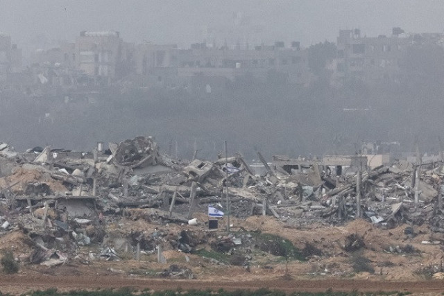 israeli flags fly next to the rubble of destroyed buildings in gaza photo reuters israeli flags fly next to the rubble of destroyed buildings in gaza photo reuters