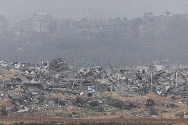 israeli flags fly next to the rubble of destroyed buildings in gaza photo reuters