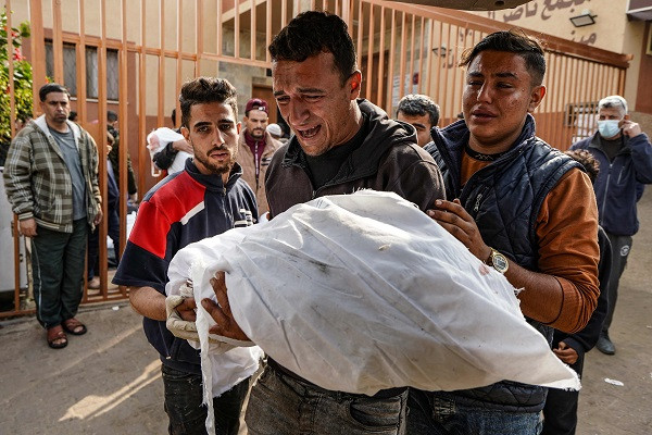 a palestinian man mourns over the body of his child killed in israeli strike at the nasser hospital in khan yunis photo afp