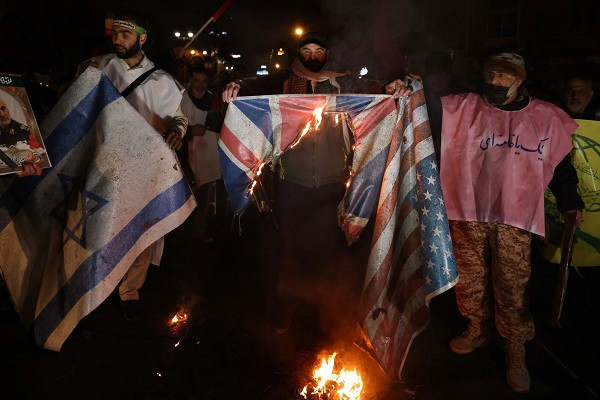 iranian protesters burn a union jack flag during a demonstration in solidarity with the palestinian people and houthis following us and british forces strikes on houthi held cities in yemen in front of the british embassy in tehran photo afp