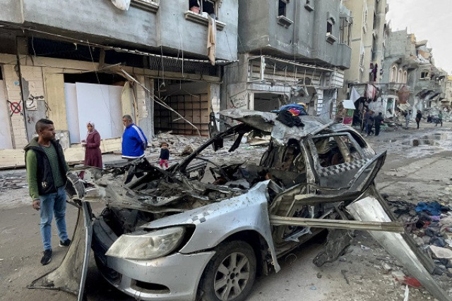 onlookers check the car in which three sons of hamas leader ismail haniyeh were reportedly killed in an israeli air strike in al shati camp west of gaza city photo afp onlookers check the car in which three sons of hamas leader ismail haniyeh were reportedly killed in an israeli air strike in al shati camp west of gaza city photo afp