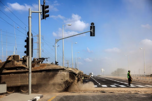 An Israeli tank takes up position near Israel's border with the Gaza Strip. PHOTO: Reuters