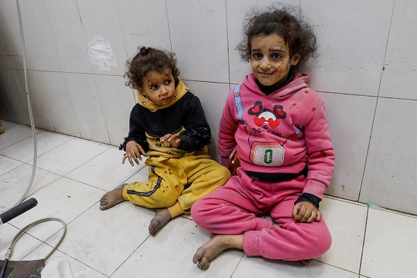 Wounded Palestinian children sit on the floor at Nasser hospital following Israeli strikes. PHOTO: Reuters