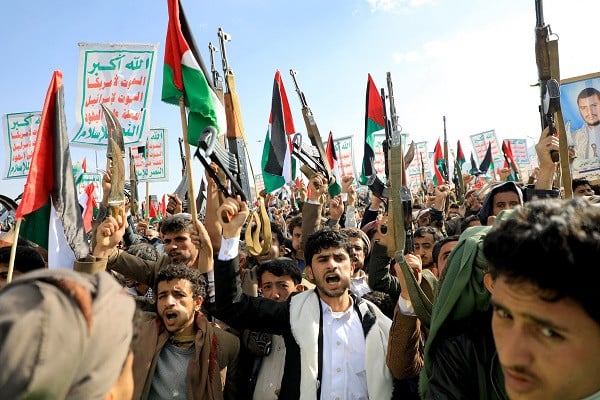 Demonstrators shout slogans, brandish their weapons and wave Palestinian flags during a march in solidarity with the people of Gaza in the Houthi-controlled capital Sanaa. PHOTO: AFP