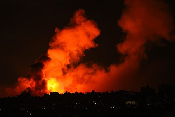 Explosions illuminate the sky during Israeli strikes on Gaza City. PHOTO: AFP