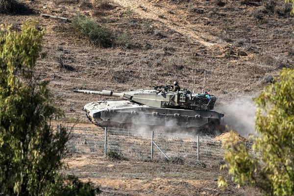 An Israeli Merkava battle tank moves along the border with the Gaza Strip by Israel's southern city of Sderot. PHOTO: Reuters