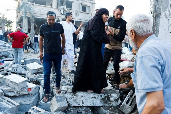 A woman cries over the rubble of her family home. PHOTO: AFP