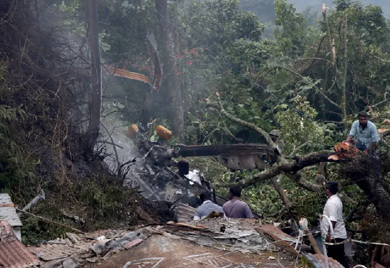 people stand near the debris of the russian made mi 17v5 helicopter after it crashed near the town of coonoor in the southern state of tamil nadu india december 8 2021 photo reuters people stand near the debris of the russian made mi 17v5 helicopter after it crashed near the town of coonoor in the southern state of tamil nadu india december 8 2021 photo reuters