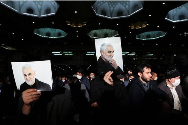 iranian men hold pictures of qassem soleimani during a ceremony to mark the second anniversary of the killing of senior iranian military commander general qassem soleimani in a us attack in tehran iran january 3 2022 photo reuters