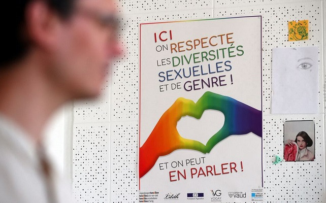 a poster is pictured on a wall at vogay an association for the sexual and gender diversity after an interview about the upcoming gay wedding vote in the swiss parliament in lausanne switzerland june 1 2020 the poster reads here we respect the sexual and gender diversity photo reuters