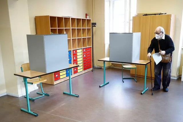 a man walks at a polling station to cast his vote in the general election in potsdam germany september 26 2021 photo reuters a man walks at a polling station to cast his vote in the general election in potsdam germany september 26 2021 photo reuters