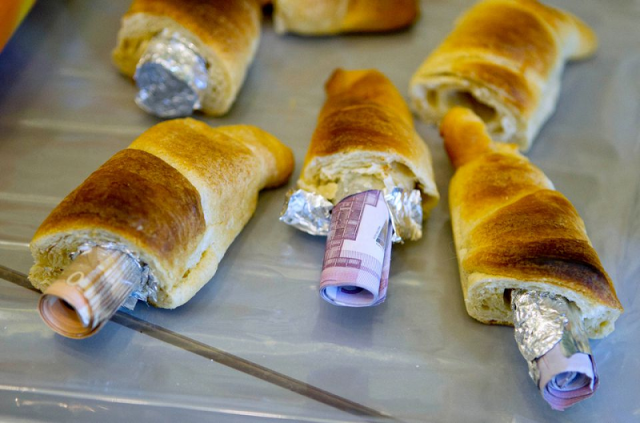 money concealed in pastries that the german customs agency zoll seized during an anti money laundering operation is displayed before the agency s annual statistics news conference at the finance ministry in berlin march 16 2012 photo reuters money concealed in pastries that the german customs agency zoll seized during an anti money laundering operation is displayed before the agency s annual statistics news conference at the finance ministry in berlin march 16 2012 photo reuters
