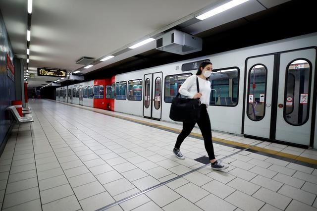 a commuter wearing a face mask walks at the cologne main station after the federal state of north rhine westphalia decided to make wearing protective masks obligatory in buses trains and shops to fight the spread of the coronavirus disease covid 19 in cologne germany photo reuters